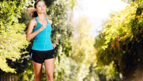 woman running through a park