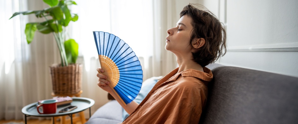 A person trying to cool down an apartment.