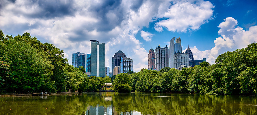 A short of a park lake with the city skiline in the background in one of the best neighborhoods in Atlanta.
