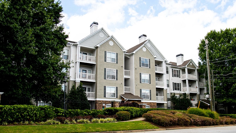 a row of low-rise multi-family buildings with green front yards in one of the best neighborhoods in Atlanta.
