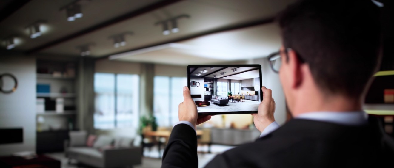 A man holding a tablet in an apartment to illustrate the pros and cons of virtual apartment tours.