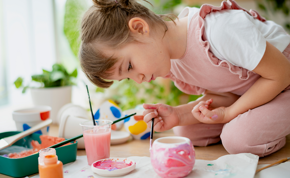 girl painting pots diy