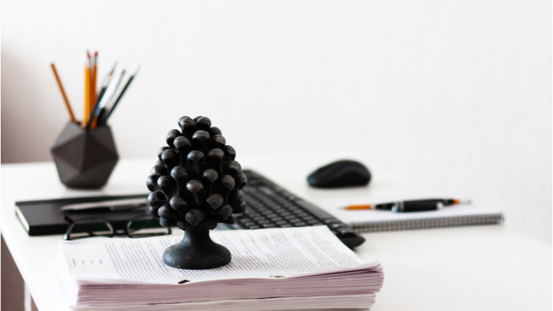 paperweight on a stash of papers on a desk