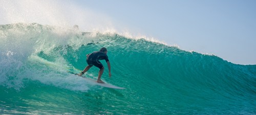 Surfing riding wave in Hawaii