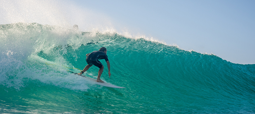 Surfing riding wave in Hawaii