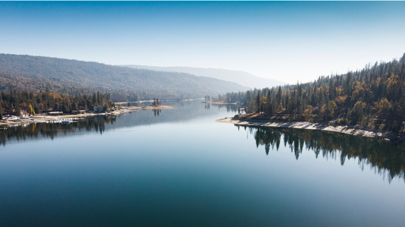 Aerial view of Bass Lake with reflection of forest in the clear water