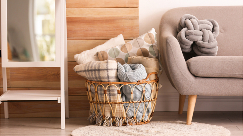 Storage basket with pillows and blankets in Boston apartment