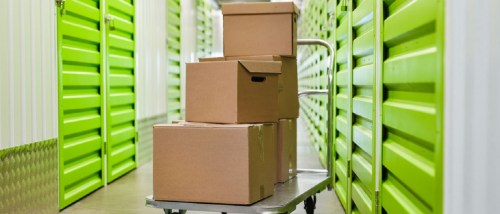 Cart with Cardboard Boxes in Self Storage Facility Empty Hall