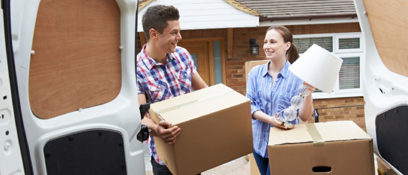 Young Couple Moving Home & Unloading Removal Van