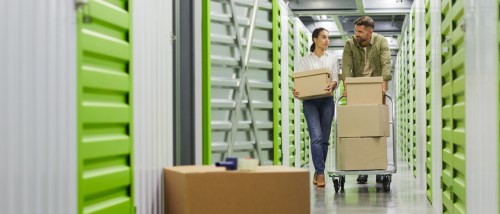 people taking boxes in a self storage unit