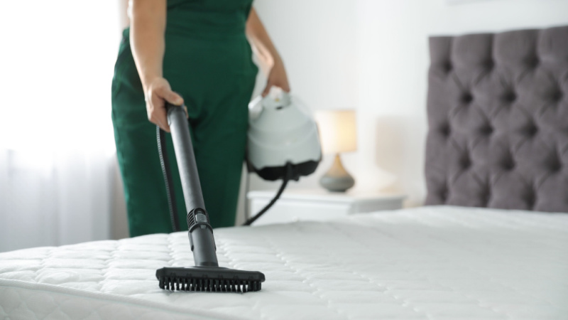 woman vacuuming a mattress