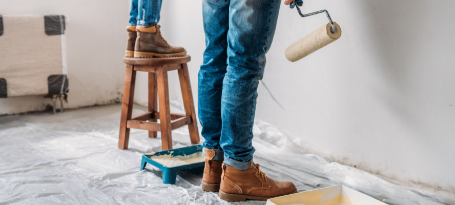 couple painting wall in new apartment