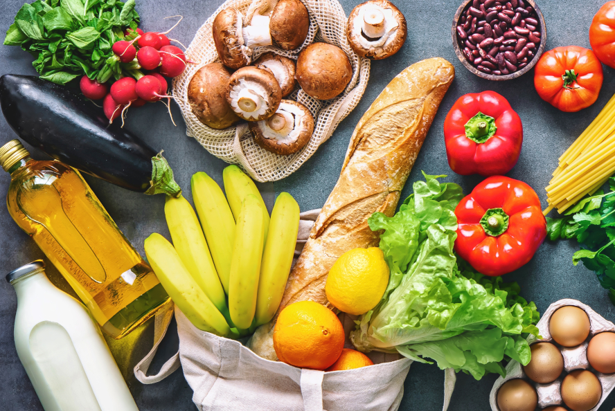 various colorful fruits and vegetables on table eggplant radishes mushrooms bread peppers lettuce oil milk bananas lemons eggs beans pasta parsley