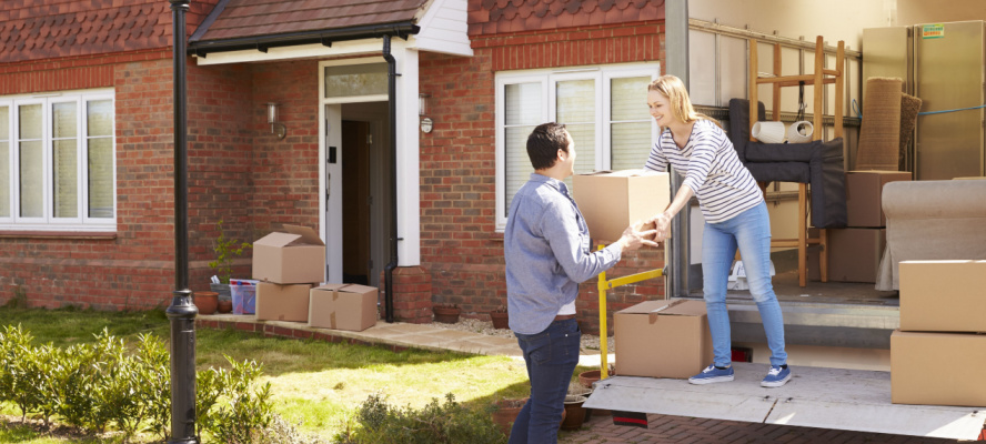 couple unloading moving boxes