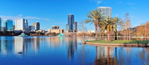 Lake Eola with palm trees and Orlando Skyline in the background on a clear sunny day