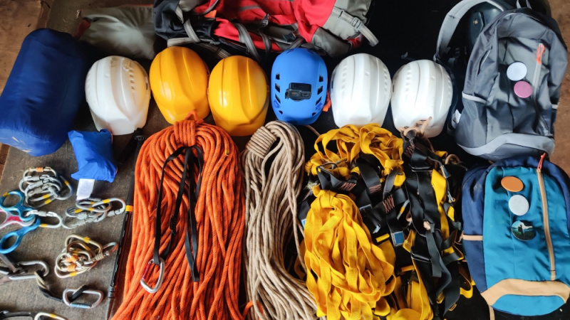 organized hiking gear for climbing placed on rustic wooden boards
