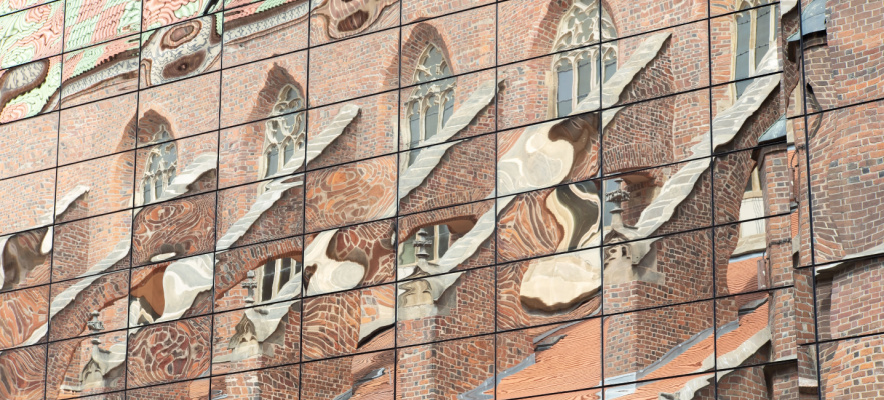 adaptive reuse gothic church reflected in new office building