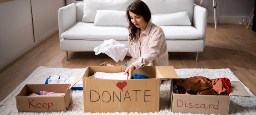 Woman donating, decluttering and cleaning up wardrobe clothes