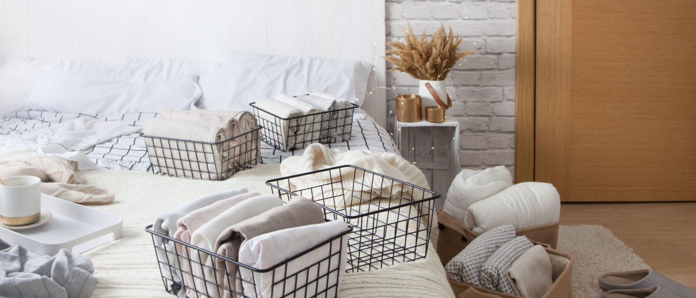Home organizing mesh containers on bed