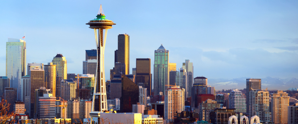 Seattle, WA, skyline at sunset wit the Seattle Space Needle in the foreground.