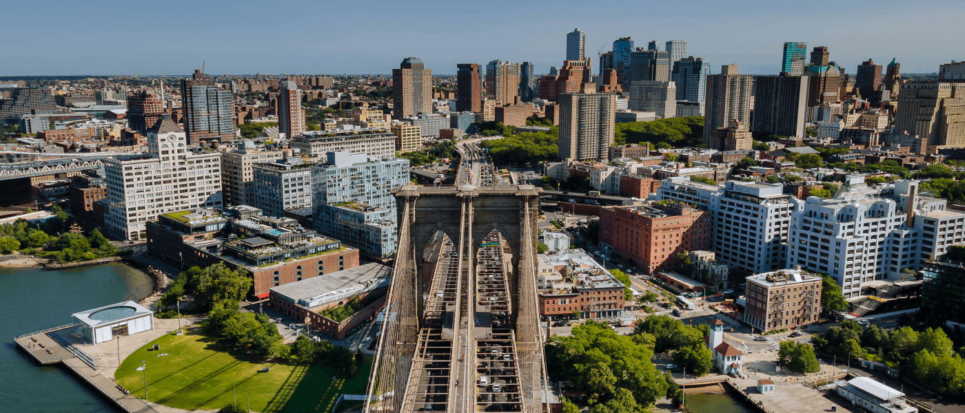 aerial view of brooklyn with numerous sky scrapers in the background