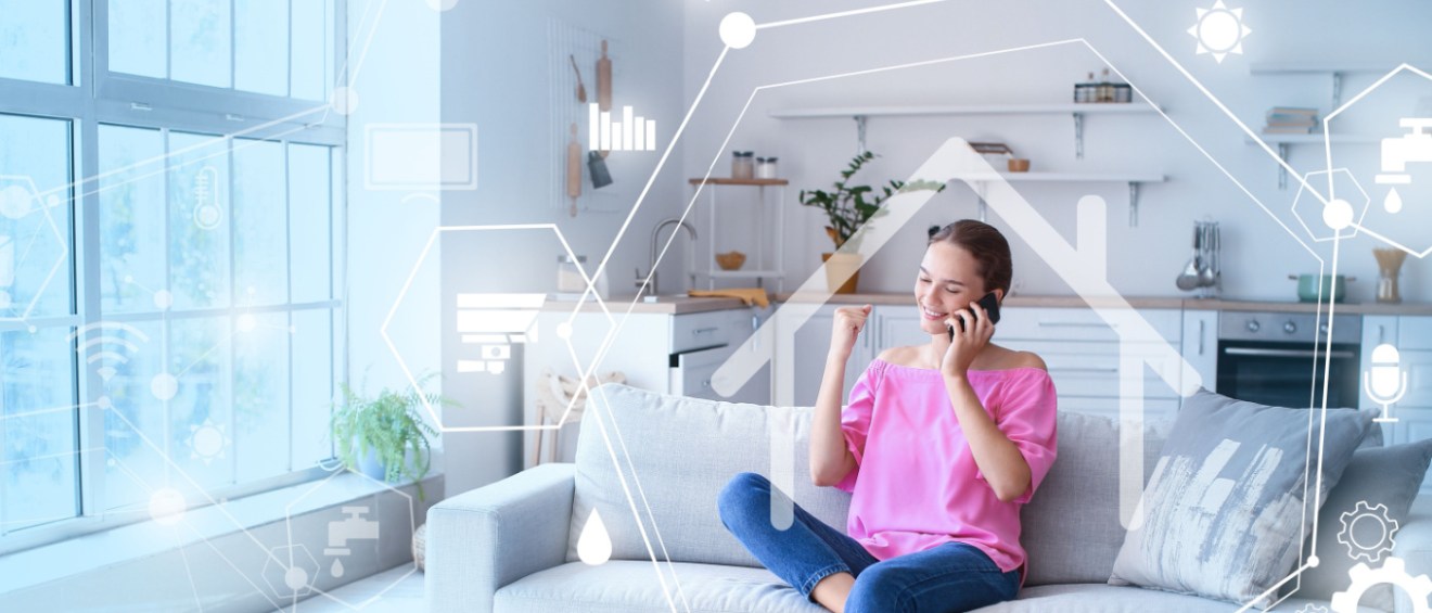 Young woman talking on mobile phone on sofa in her rental apartment.