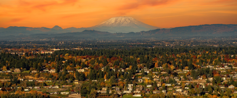 aerial view of buildings in vancouver washington at sunset with the snow covered mountain top in the background