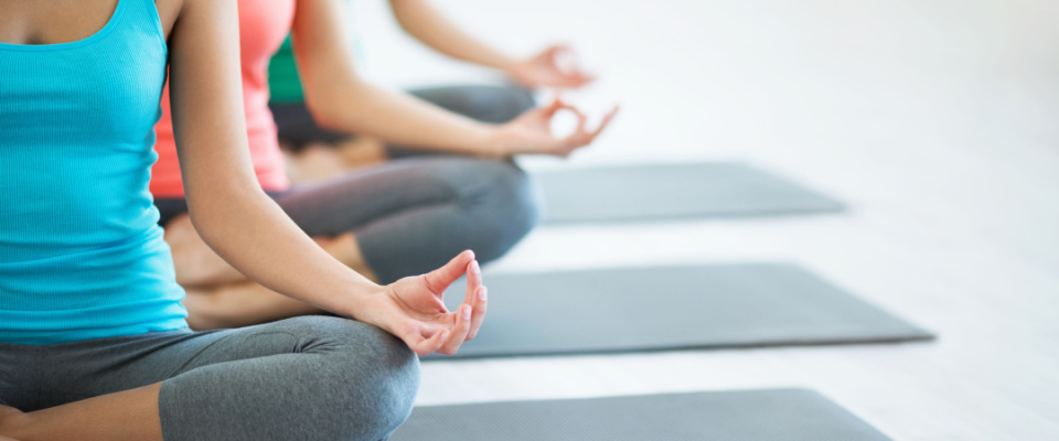 Young women doing yoga at the yoga studio at their apartment building.