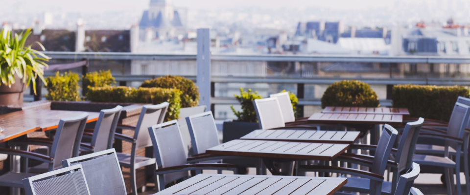 tables and chairs at a rooftop bar