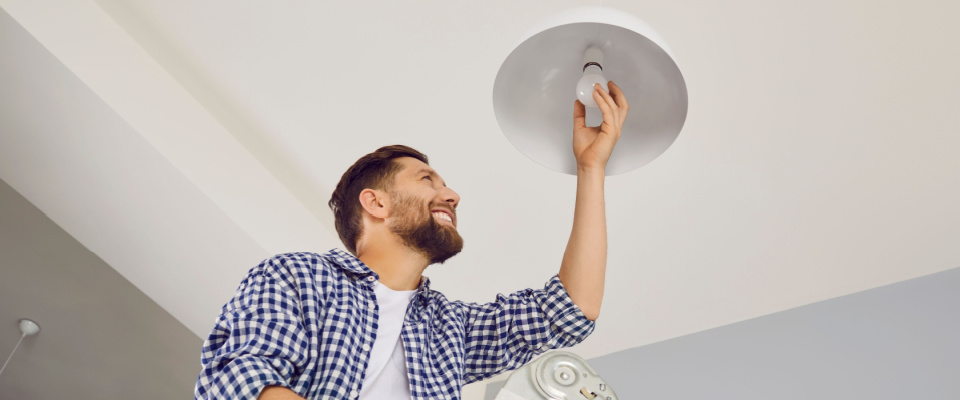 man screwing in lightbulb 
