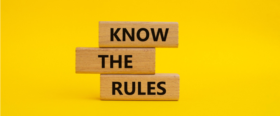 Know the rules symbol. Wooden blocks with the words Know The Rules on yellow background. 