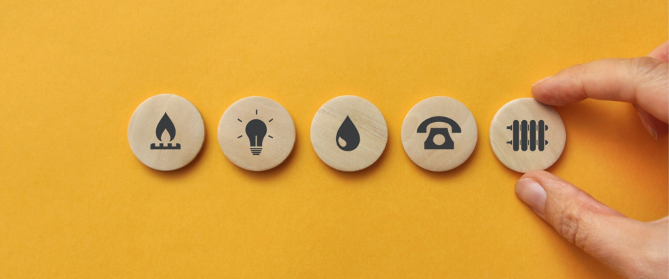 Utility icons on wooden mugs. A symbol of the necessary services in a rental apartment.
