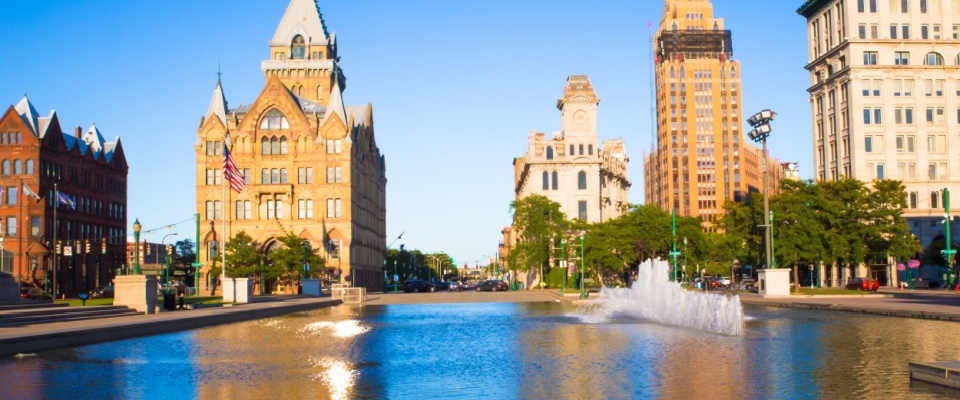Downtown Syracuse New York with view of historic buildings and fountain at Clinton Square.