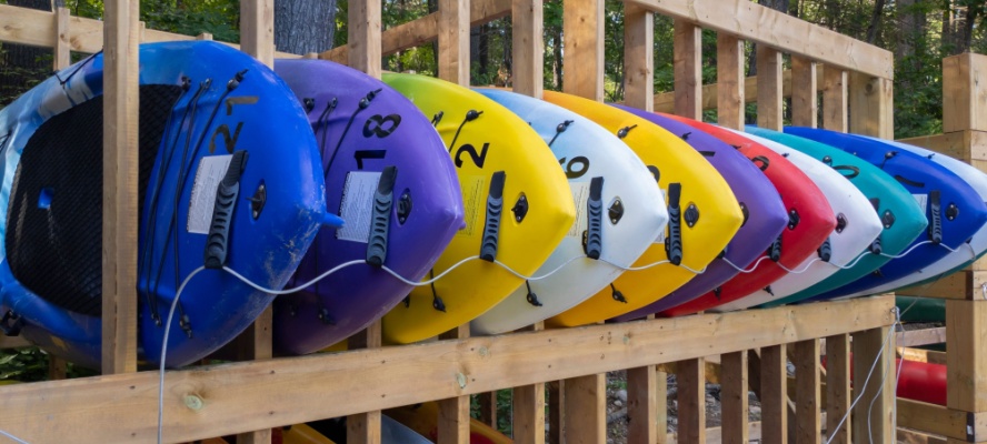 paddleboards stacked on a rack at a rental business facility