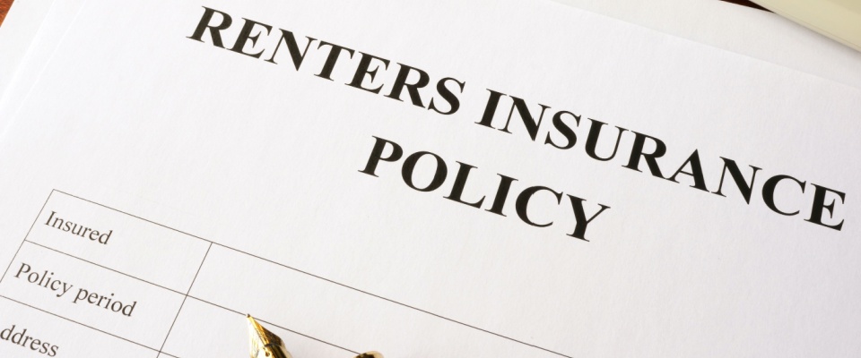 A blank renters insurance policy form lies on a desk, ready to be filled in, with a pen placed on top of it.