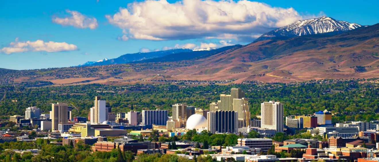 Downtown Reno skyline, Nevada, with hotels, casinos and the surrounding High Eastern Sierra foothills.