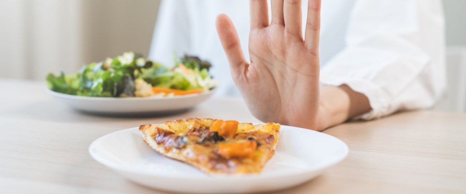 Woman refuses food that contains allergens. 