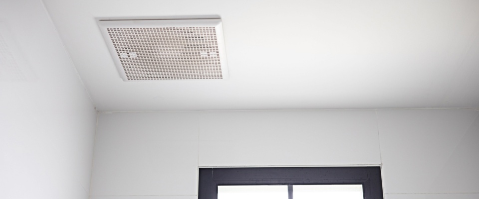 The exhaust fan is installed on the ceiling near the skylight.