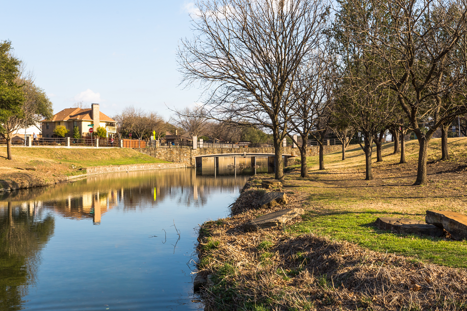 view of park and pond in plano tx