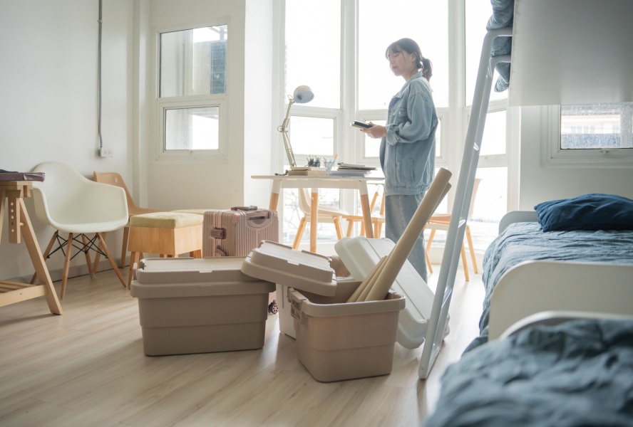 Woman moving into new home with boxes on the floor