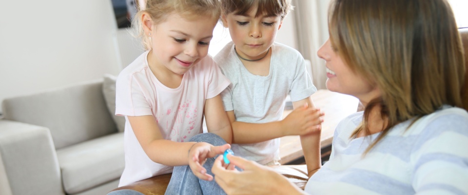Kids getting candies from their mom.