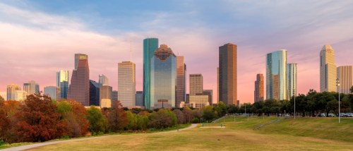 Houston skyline with tall buildings and a beautiful pink sky.