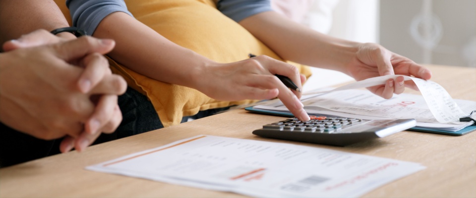 Young couple calculating their budget for the month. 