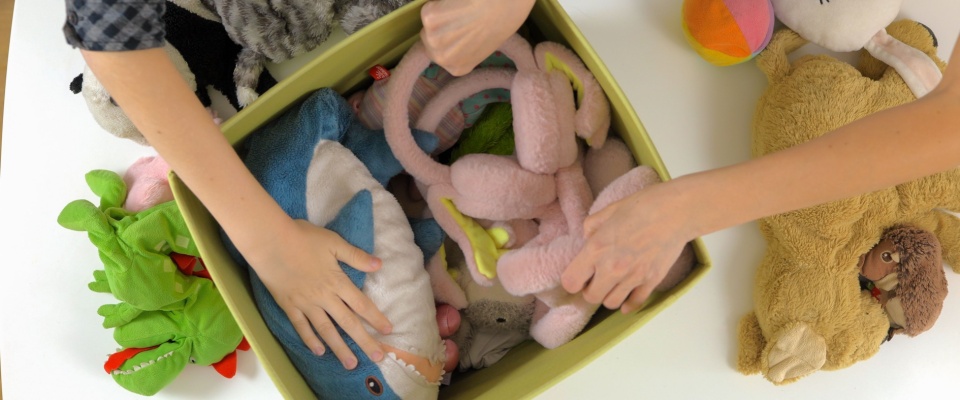 Mother and son preparing old toys for donation.
