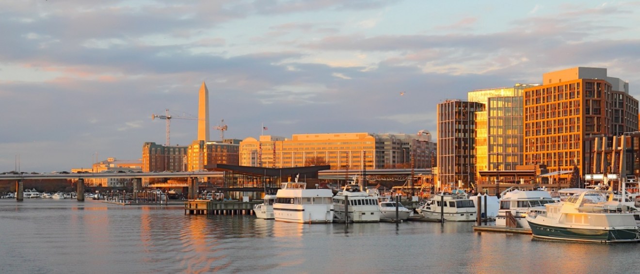 A waterfront view of Washington, D.C. underneath an overcast sky, as seen from the Wharf.