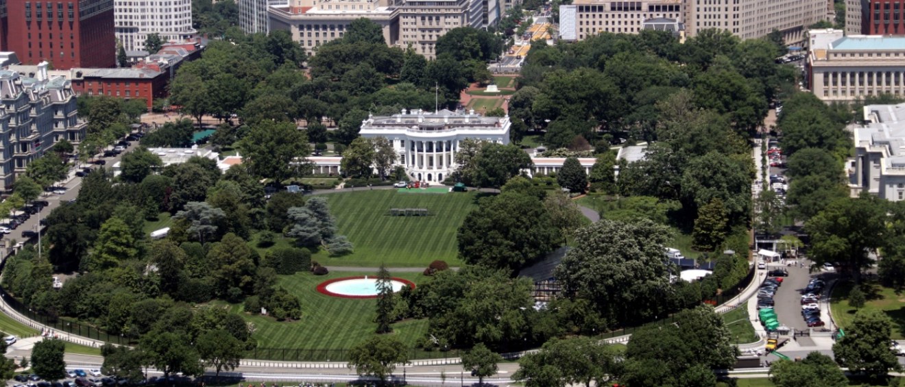 The iconic White House in Washington, D.C., standing proudly amidst the vibrant beauty of the city.