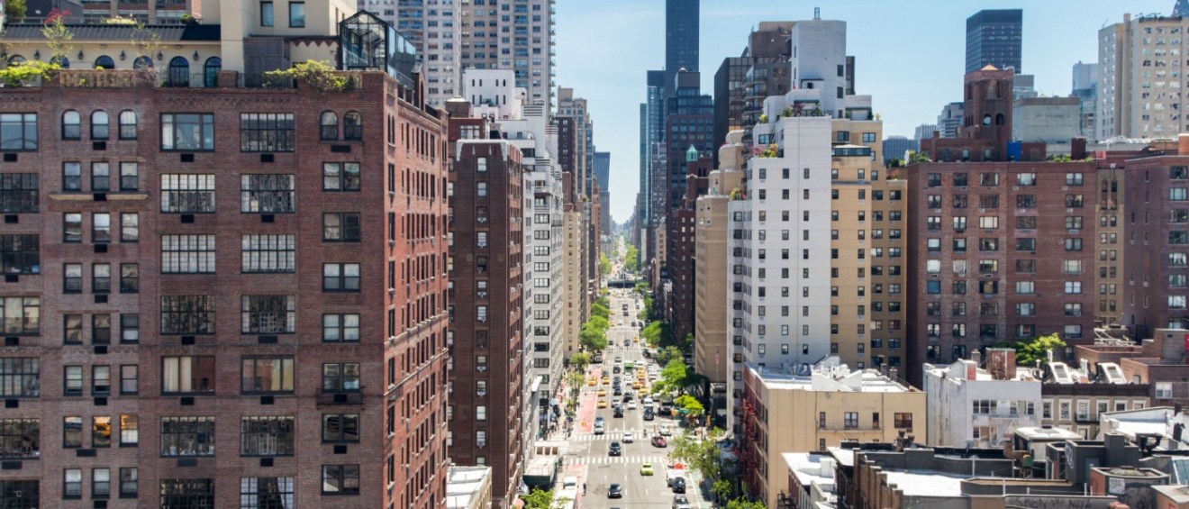 Overhead view First Avenue with traffic drivings through the buildings of Manhattan in New York City, as seen from the Roosevelt Island Tramway.