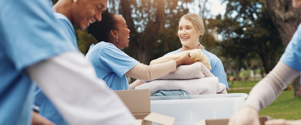 A group of volunteers gathered in a park, working together on a sustainability or NGO project.