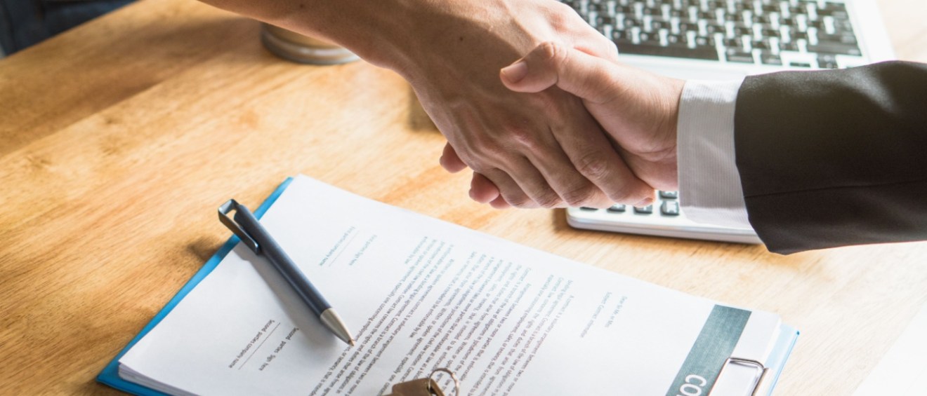 The renter and landlord shake hands after successfully negotiating rent.