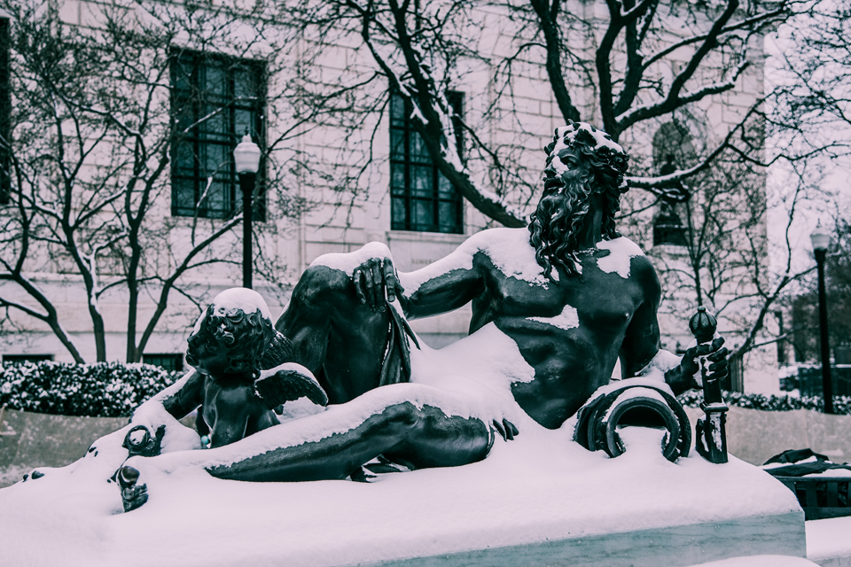 statue with snow in winter in front of art museum in detroit